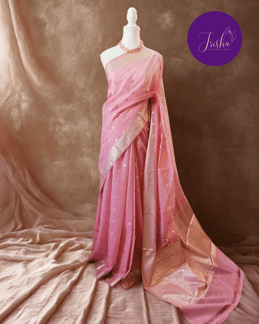 Soft Pure Chanderi Cotton Saree in Light Pink shade with Small floral buttis woven all over saree. Silver zari border with woven floral motifs on both sides.