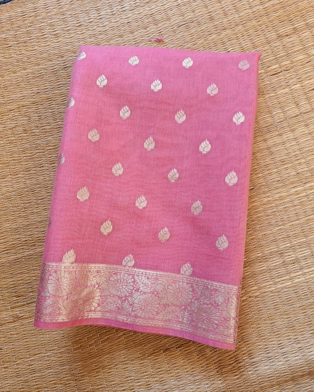 Soft Pure Chanderi Cotton Saree in Light Pink shade with Small floral buttis woven all over saree. Silver zari border with woven floral motifs on both sides.