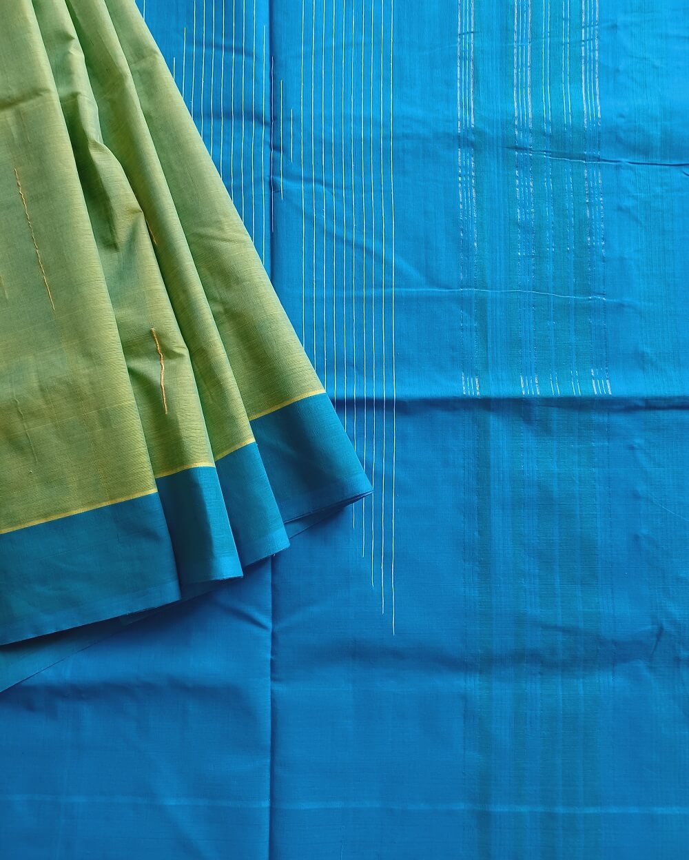 Khus Khus natural fibres and cotton handwoven saree. Light green and yellow dual tone body with a fresh light blue border and pallu.