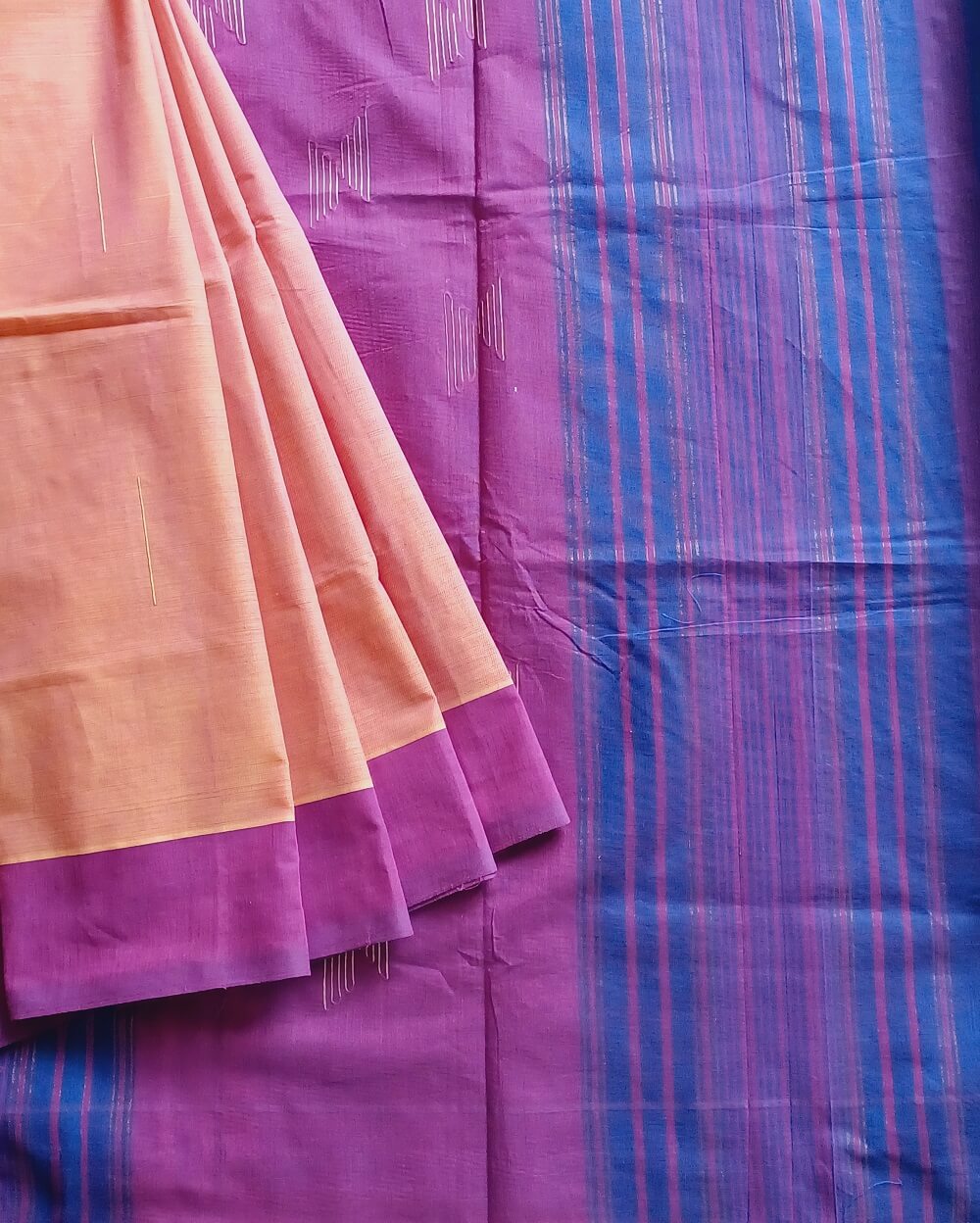 Khus Khus natural fibres and cotton handwoven saree. Light yellow and pink dual tone body with a purple border and purple and blue pallu.