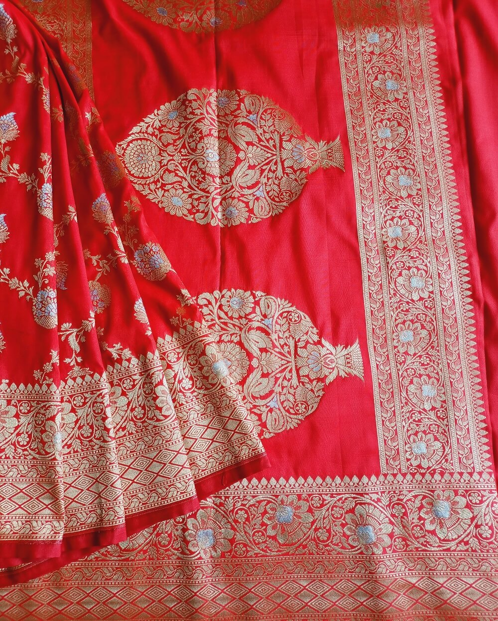 Katan Silk Saree in Red shade with floral and creeper motifs in sona rupa or gold and silver weaves all over the body, It has been woven in famous jaal weaves.