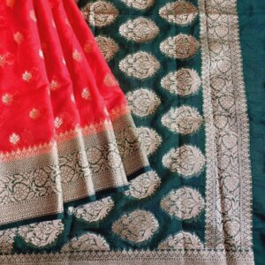 Georgette Saree in Red Shade, Khaddi Border with Gold zari weaves in the famous Banarasi floral buttis work all over the saree. Border has Banarasi floral motif.