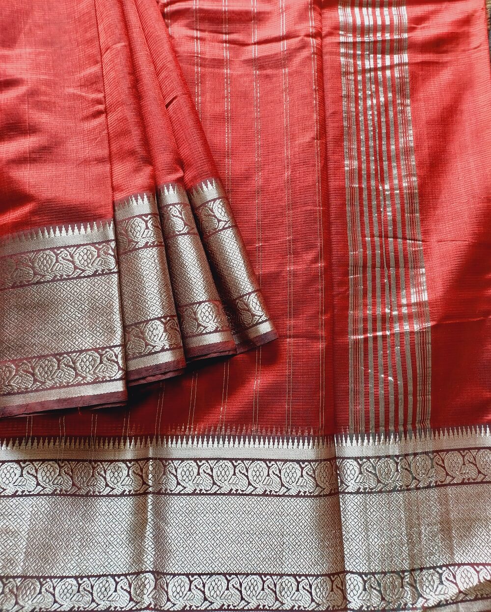 Mangalgiri Silk Cotton saree woven in Pure mulberry silk with cotton.Deep Garnet Red shade with Silver Zari border.Border is woven in Kanchipuram Peacock motif