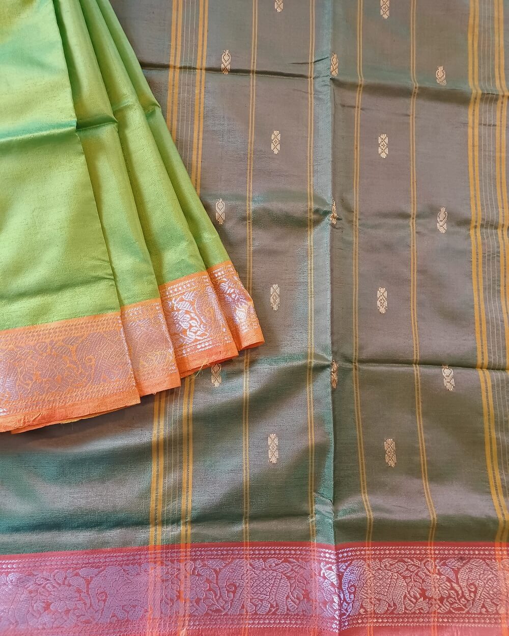 Banana Pith Saree also known as Vaazhainaar pattu. Fresh Grass Green. Pallu is in dark green shade. Border is light orange. A very Beautiful and fresh combination also known as tone on tone saree, as it's green with green combination.