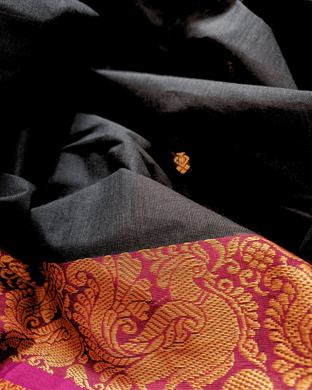 Chettinad Cotton Saree in Black with Pink border, It has Buttas on saree with Thread woven border in Peacock and Rudraksham motifs and Simple Pallu with stripes.