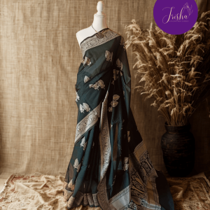 Banarasi Cotton Saree in Bottle Green Shade with Cream resham threads woven all over. It has traditional Banarasi floral and kali (bud) motifs. It has a very unique pallu with beautiful traditional Banarasi floral motifs. A very unique collection in cotton woven with a very rare traditional pattern.