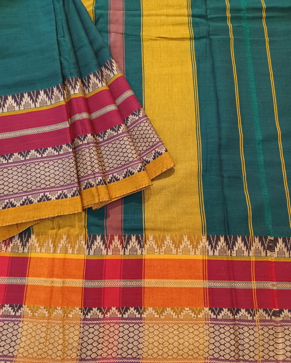 Narayanpet Cotton Saree in Dark Emerald Green Shade with Maroon and Yellow border. It's Plain saree with Thread woven border with traditional motifs.