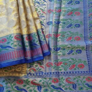 Banarasi Katan Silk saree in Grey shade with floral motifs in light gold zari weaves all over the body. It has been woven in the most famous jaal weaves.