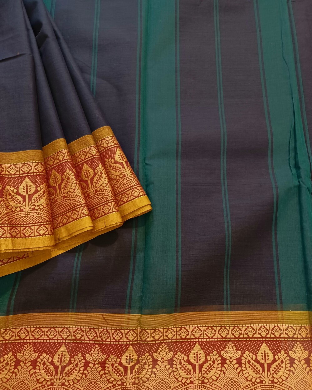 Chettinad Cotton Saree in Dark Blue Shade with Mustard Yellow border. It's plain saree with Thread woven border with leaf motifs and Simple Pallu with stripes.