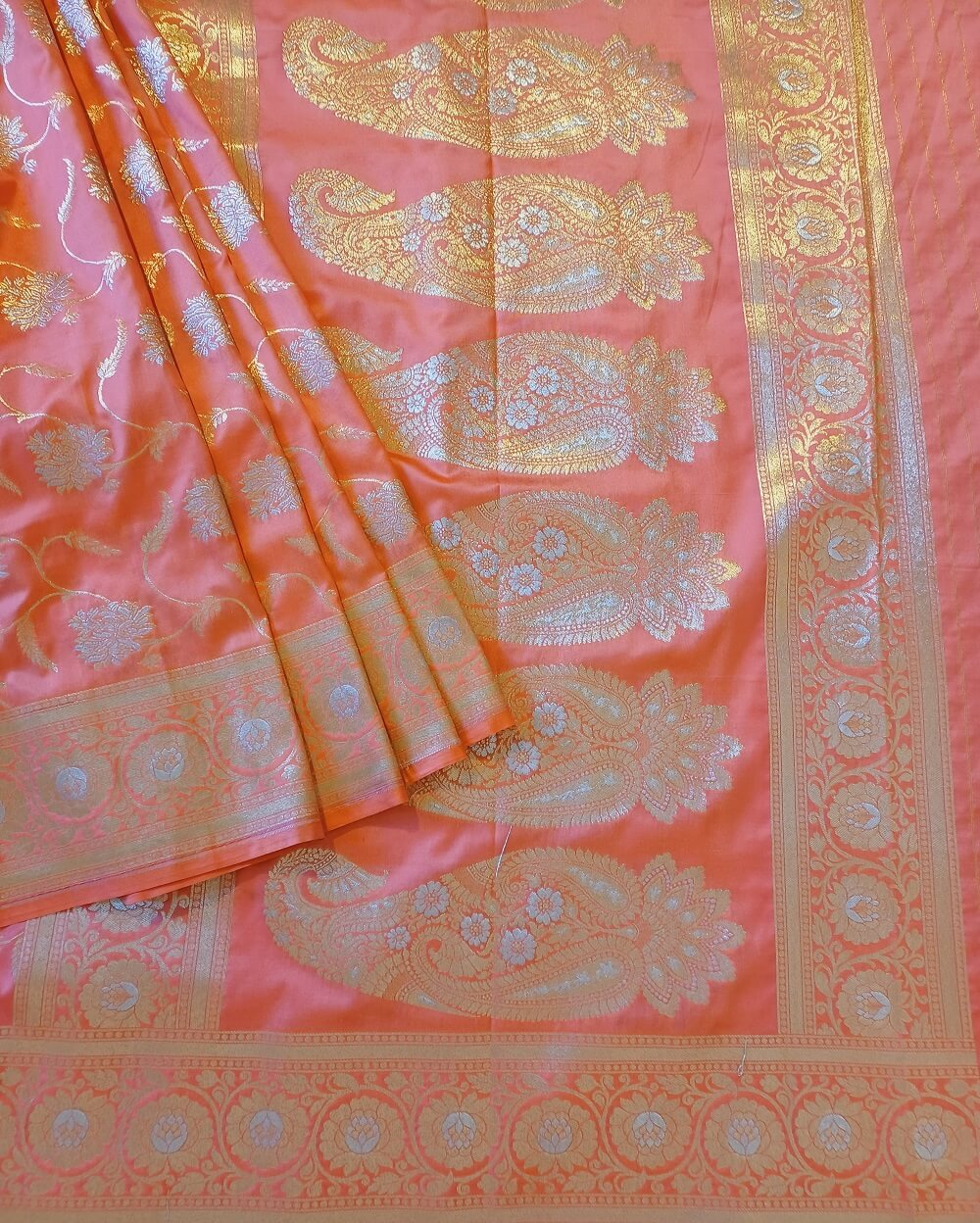 Katan Silk Saree in Light Pink shade with floral and creeper motifs in sona rupa or gold and silver weaves all over the body. It has been woven in jaal weaves.