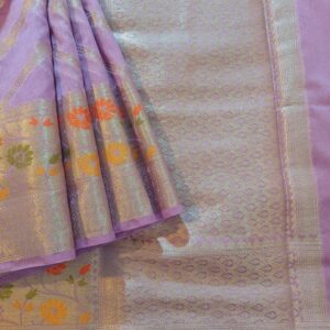 Georgette Saree in Purple shade with Silver zari weaves in the famous Banarasi Jaal work. Border has Banarasi floral motifs with Meena work,