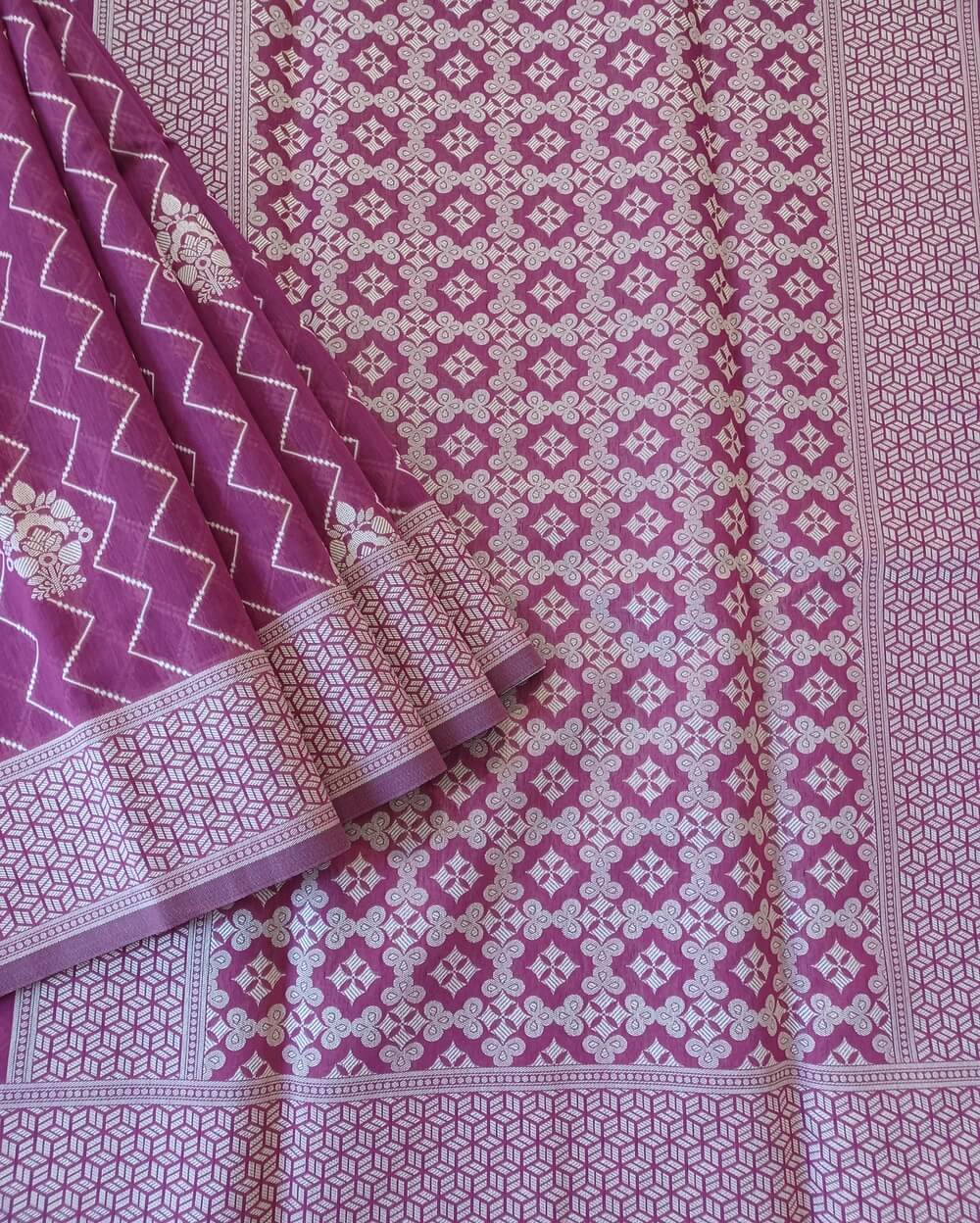 Banarasi Cotton Saree in Wine Shade with Cream resham threads woven all over. It has traditional Banarasi floral motifs and zig zag vertical pattern lines .