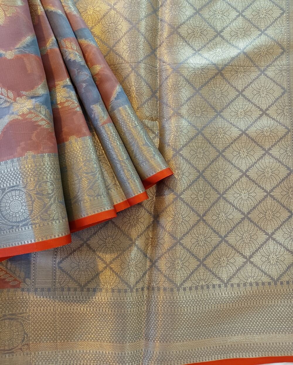 Chanderi Saree silk cotton in Bluish grey with brick red with beautiful and traditional Rangkaat work. Saree has floral and diamond shape motifs in gold zari.