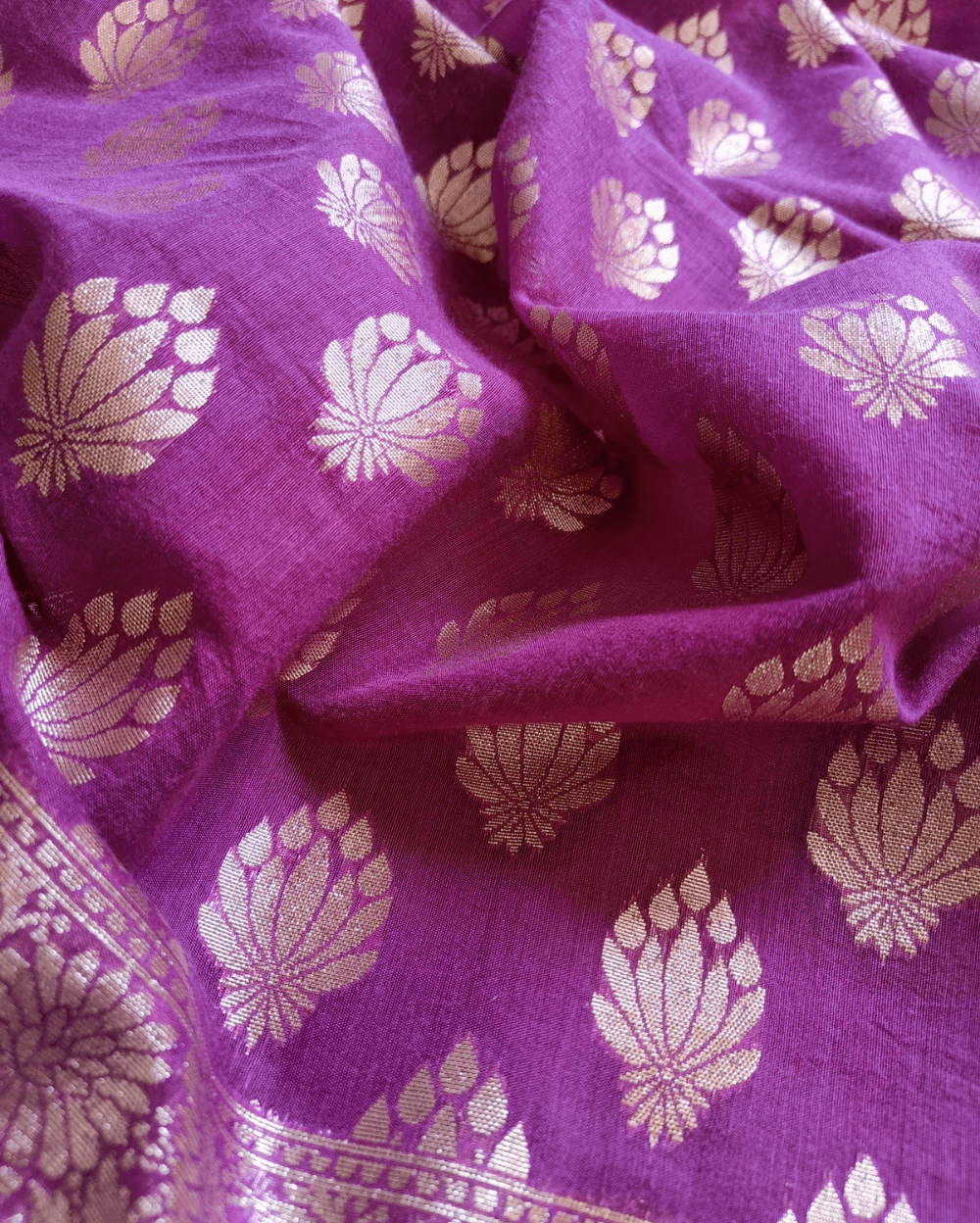 Soft Pure Chanderi Cotton Saree in Purple Shade with Floral motifs woven all over saree. It has Light Gold zari border with woven floral motifs on both sides.