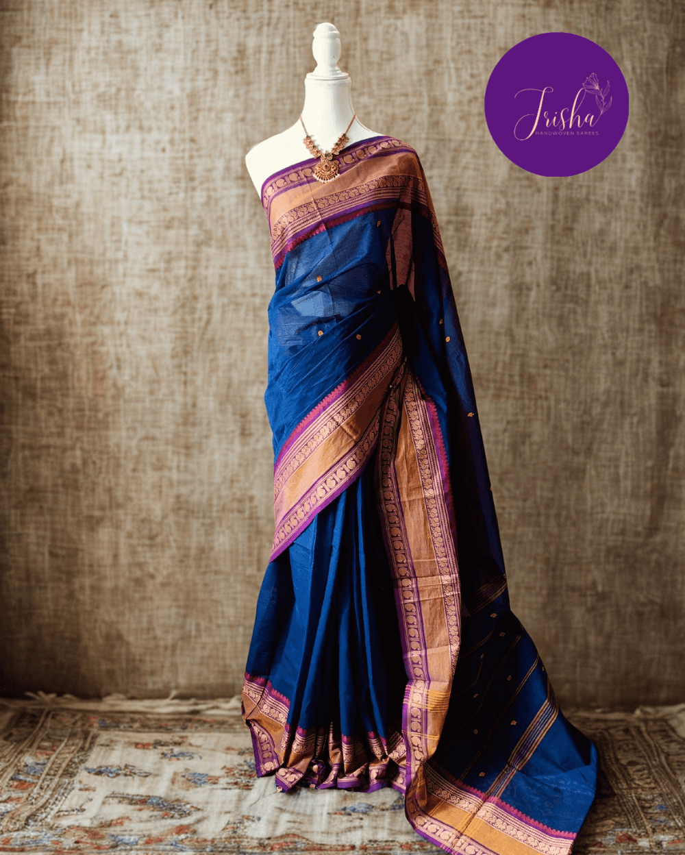 Handloom Kanchi Cotton Saree in Pleasant Shankhpushpi flower Blue with Purple border, it has Buttas on Saree and Thread Border with traditional Peacock and Mango Motifs.