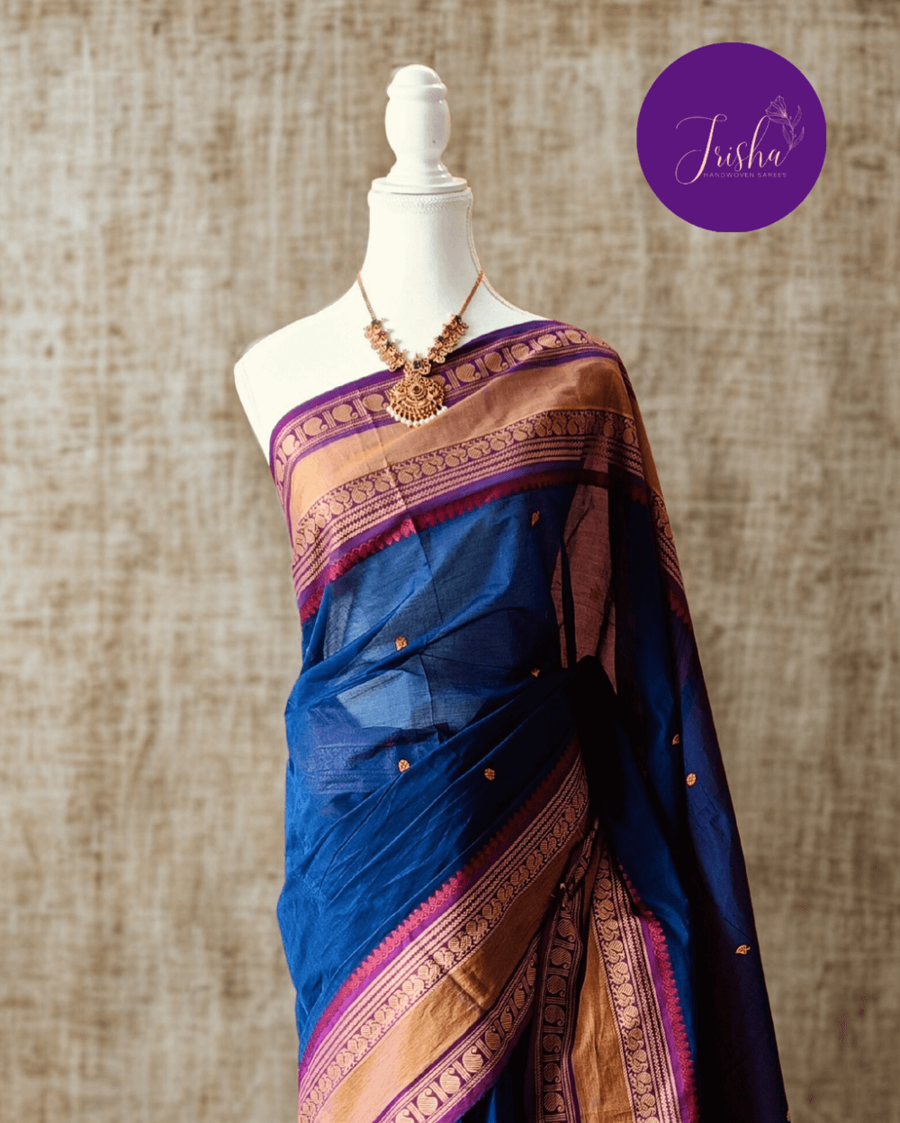 Handloom Kanchi Cotton Saree in Pleasant Shankhpushpi flower Blue with Purple border, it has Buttas on Saree and Thread Border with traditional Peacock and Mango Motifs.
