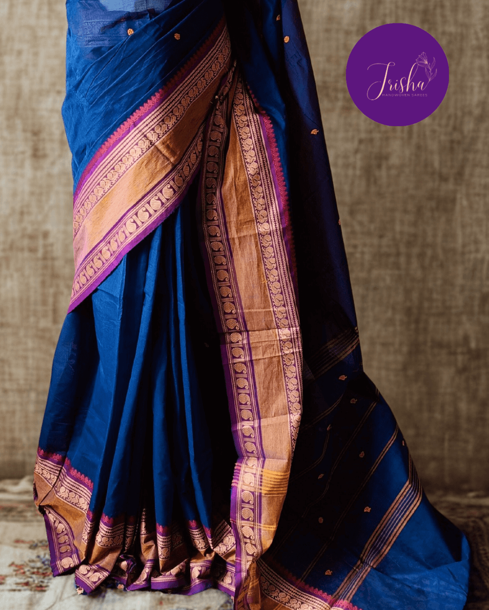 Handloom Kanchi Cotton Saree in Pleasant Shankhpushpi flower Blue with Purple border, it has Buttas on Saree and Thread Border with traditional Peacock and Mango Motifs.