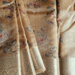 Tussar silk saree in Golden Beige shade with floral digital prints, it has a very elegant silver border with small motifs. A very contemporary earthy shade with subtle shine and classic prints. Saree comes with a blouse piece in small prints.