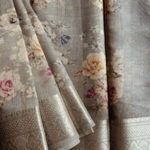 Tussar silk saree in Grey shade with floral digital prints, it has a very elegant silver border with small motifs. A very contemporary earthy shade with subtle shine and classic prints. Saree comes with a blouse piece in small prints.