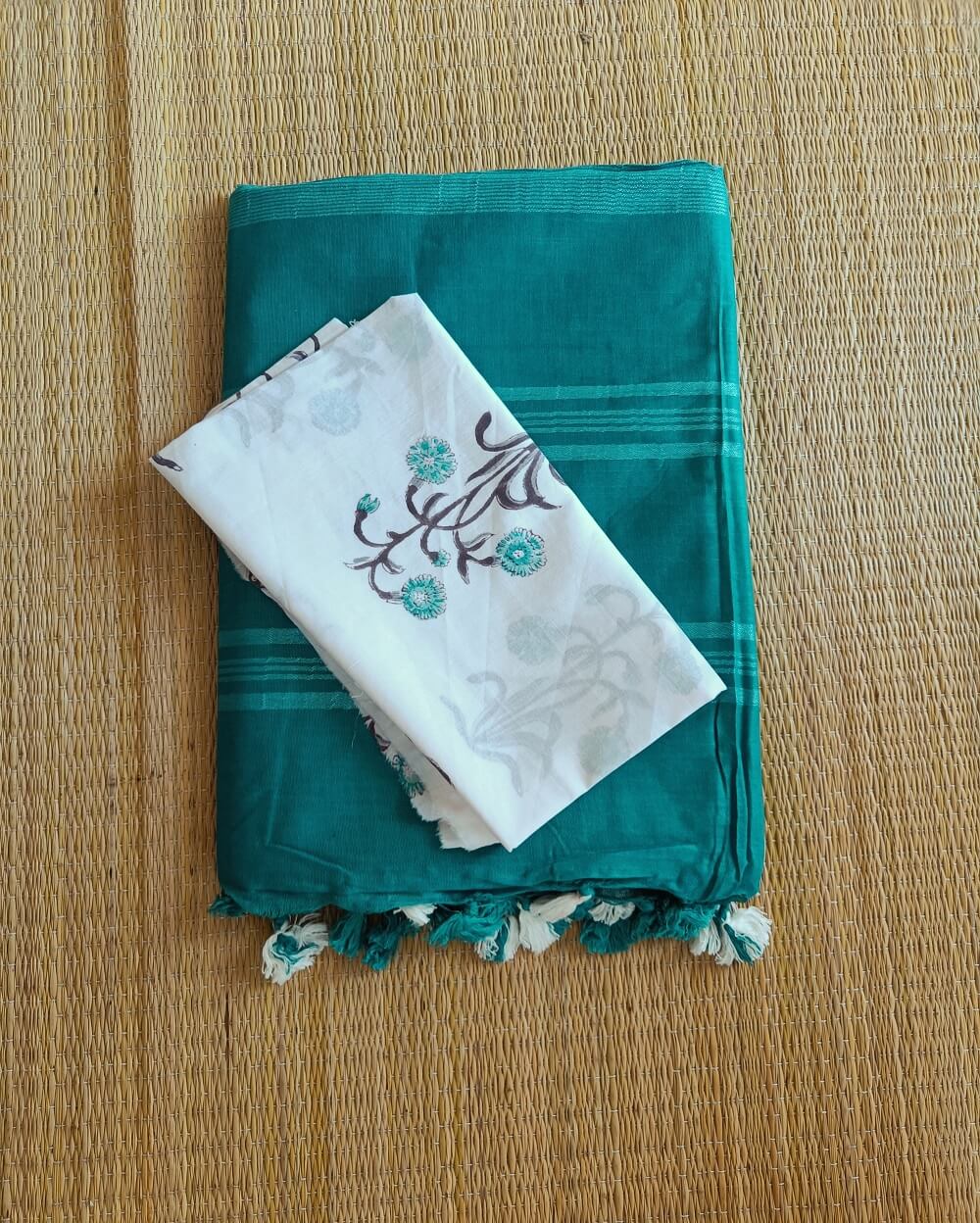 Cyan Blue linen saree with silver tissue zari border and contrast handcrafted - hand block printed mul mul cotton blouse piece, The Linen saree comes with a plain body in very soothing shade with a subtle silver tissue zari border. The pallu is simple with silver stripes. The blouse piece is running blouse piece that comes along with saree and the additional one is a beautiful hand block printed.