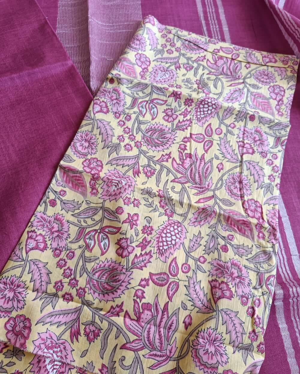 Dark Pink linen saree with silver tissue zari border and a light yellow handcrafted - hand block printed mul mul cotton blouse piece, The Linen saree comes comes with a plain body in very soothing shade with a subtle silver tissue zari border. The pallu is simple with silver stripes. The blouse piece is running blouse piece that comes along with saree and the additional one is a beautiful hand block printed