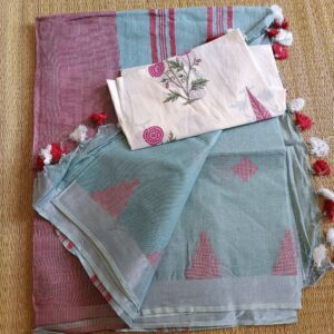 Ice Blue linen saree with silver tissue zari border and contrast handcrafted - hand block printed mul mul cotton blouse piece, The Linen saree comes with small geometric thread motifs woven all over the body in pink shade with a subtle silver tissue zari border. The pallu is simple with pink stripes. The blouse piece is running blouse piece that comes along with saree and the additional one is a beautiful hand block printed.