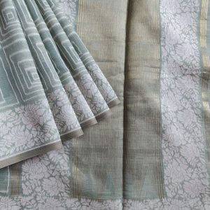 Light Sage Green Linen saree with Mul Mul cotton fabric .This Linen saree has thread woven geometric square patterns all over the saree. The pallu is simple with a small line of zari woven . It's has beautiful floral border that compliments the over all unique look of the saree. The designs are very contemporary and exclusive.