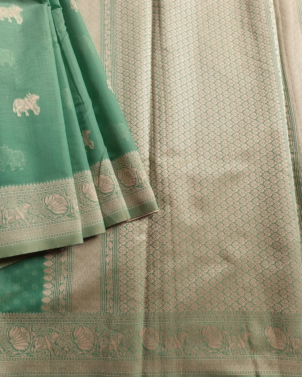 Banarasi Cotton Saree in Green colour with Cream resham threads woven all over. It has traditional Banarasi animal motifs which is a very famous weave.