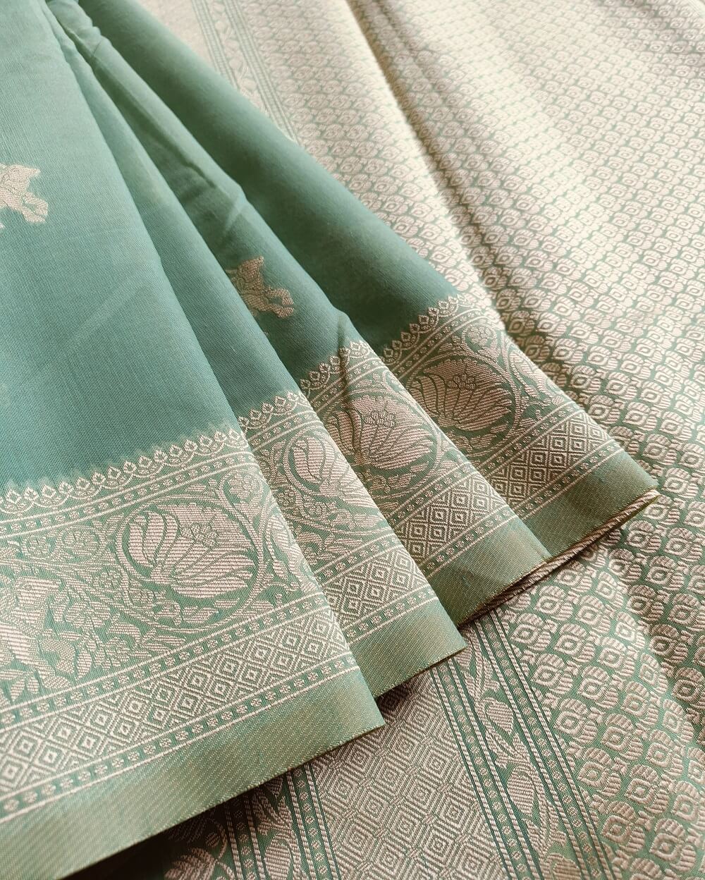 Banarasi Cotton Saree in Green colour with Cream resham threads woven all over. It has traditional Banarasi animal motifs which is a very famous weave.