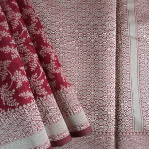 Banarasi Cotton Saree in Maroon colour with Cream resham threads woven all over. It has traditional Banarasi floral motifs in jaal weaves which is a very famous traditional weave where the motifs are interconnected throughout the saree.