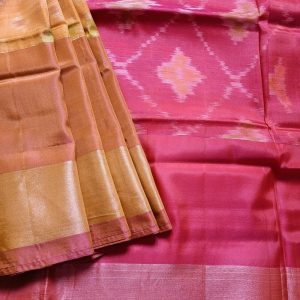 Mulberry silk mix saree woven in ikkat handloom weaves. This Ikkat silk saree has Tissue zari borders with classic colour combinations. Mustard Yellow with pinkish deep yellow dual tone and tissue gold border. It has a lovely bright Pink Pallu and plain blouse piece that matches pallu.