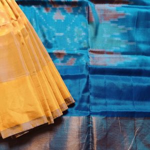 Mulberry silk mix saree woven in ikkat handloom weaves. This Ikkat silk saree has Tissue zari borders with classic colour combinations. Golden Yellow with greyish blue and tissue gold border. It has a lovely bright Copper Sulphate Blue Pallu and plain blouse piece that matches pallu