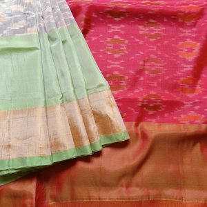 Mulberry silk mix saree woven in ikkat handloom weaves. This Ikkat silk saree has Tissue zari borders with classic colour combinations Silver grey with fresh light green and tissue gold border. It has a lovely bright Kumkum red Pallu and plain blouse piece that matches pallu.