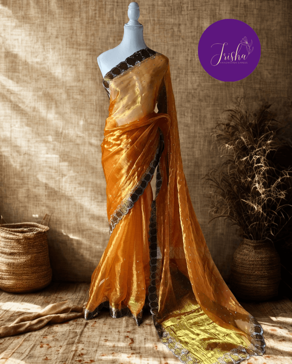 Jimmy Choo Organza silk saree in Yellow shade with black and white Swarovski crystal work in the border. The saree has Swarovski work on the shoulder part and the skirt portion of the saree in the form of small buttas. The Pallu is beautifully done in a C shape work pattern.