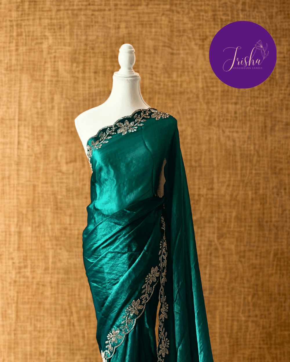 Forest Green fendy silk saree with Jharkhan Diamond Stone crystal work in Border throughout the saree and Pallu .The Pallu is beautifully done in a C shape work pattern. The shade has a light dual tone effect. Blouse has back design in Swarovski crystal work and sleeves potion has diamond stone work done.