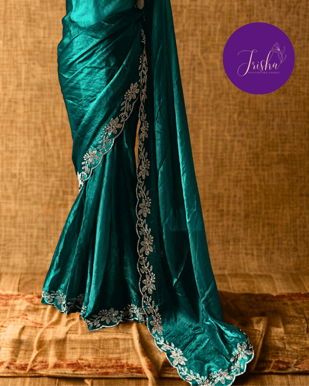 Forest Green fendy silk saree with Jharkhan Diamond Stone crystal work in Border throughout the saree and Pallu .The Pallu is beautifully done in a C shape work pattern. The shade has a light dual tone effect. Blouse has back design in Swarovski crystal work and sleeves potion has diamond stone work done.