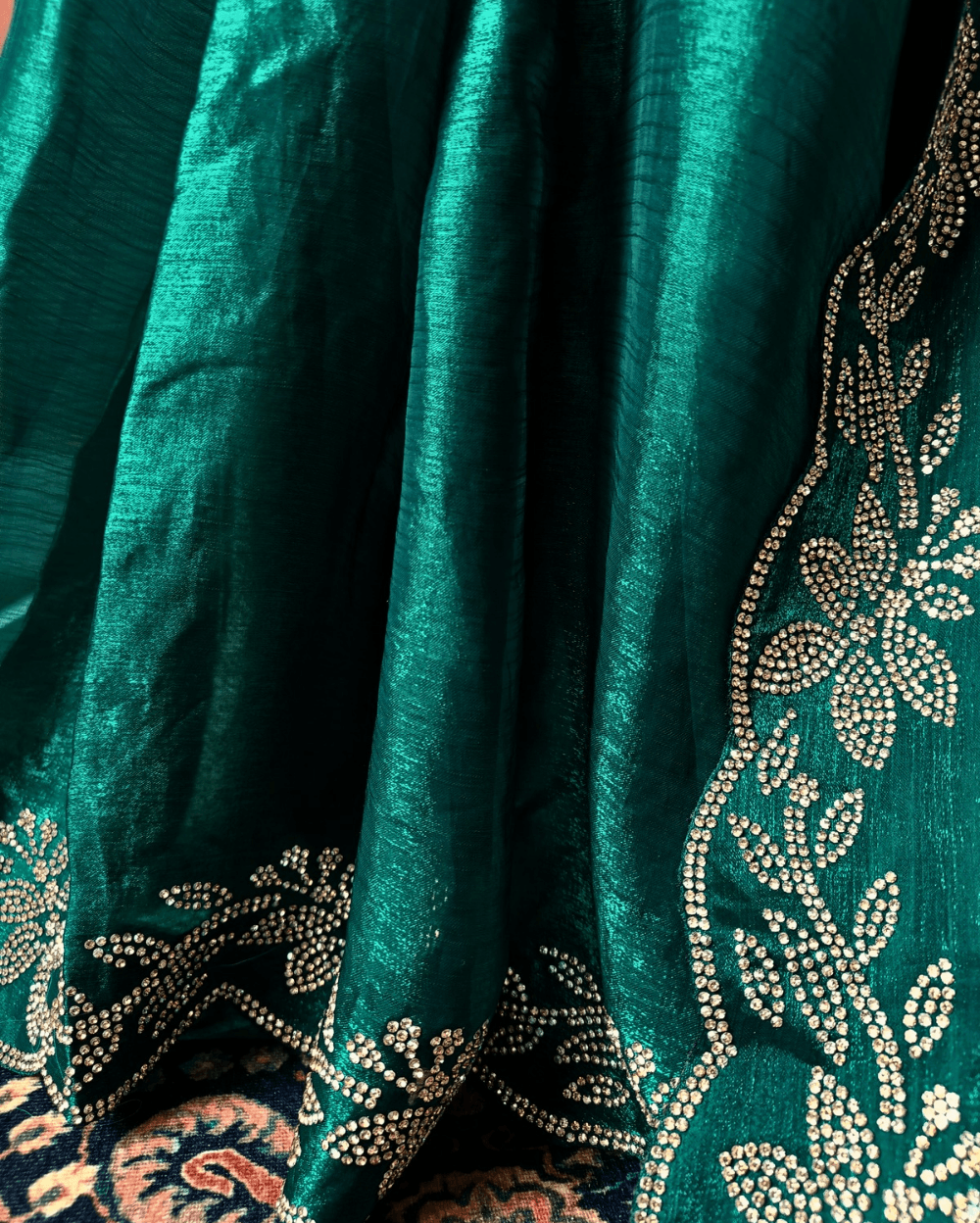 Forest Green fendy silk saree with Jharkhan Diamond Stone crystal work in Border throughout the saree and Pallu .The Pallu is beautifully done in a C shape work pattern. The shade has a light dual tone effect. Blouse has back design in Swarovski crystal work and sleeves potion has diamond stone work done.