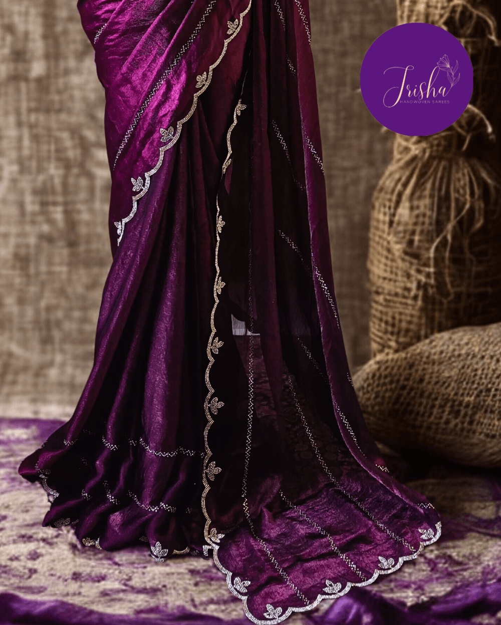 Purple fendy silk saree with Swarovski crystal work all over the shoulder and pallu portion in stripes pattern. Border throughout the saree and Pallu has diamond stone work .The saree in the skirt portion has 2 lines of striped Swarovski crystal work. The Pallu is beautifully done in a C shape work pattern. The shade has a light dual tone effect. Blouse piece has back design in Swarovski crystal work and sleeves potion has diamond stone work done.