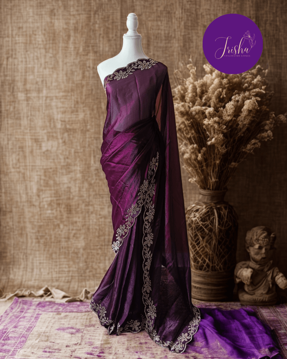 Wine Purple fendy silk saree with Jharkhan Diamond Stone crystal work in Border throughout the saree and Pallu .The Pallu is beautifully done in a C shape work pattern. The shade has a light dual tone effect. Blouse has back design in Swarovski crystal work and sleeves potion has diamond stone work done.