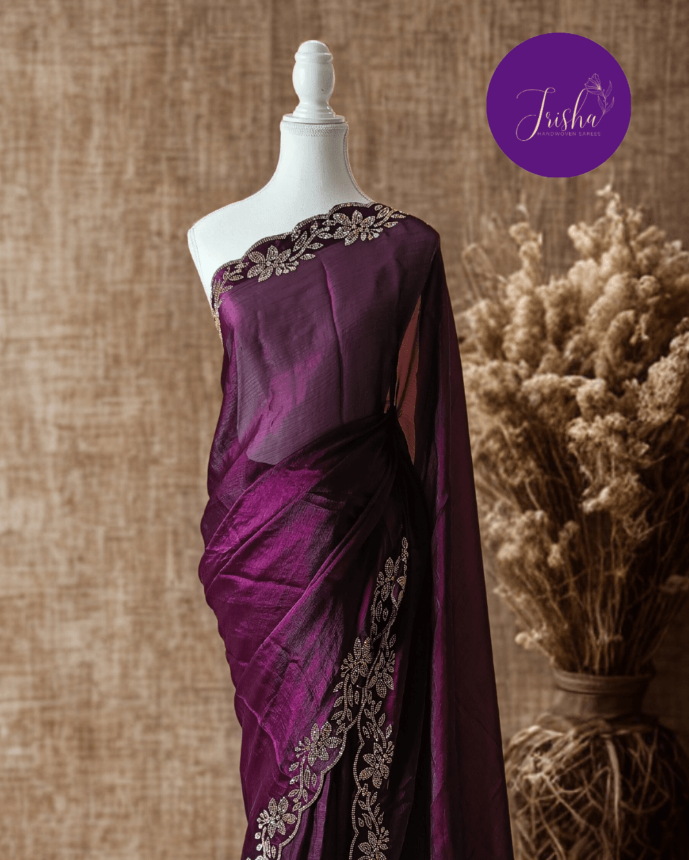 Wine Purple fendy silk saree with Jharkhan Diamond Stone crystal work in Border throughout the saree and Pallu .The Pallu is beautifully done in a C shape work pattern. The shade has a light dual tone effect. Blouse has back design in Swarovski crystal work and sleeves potion has diamond stone work done.