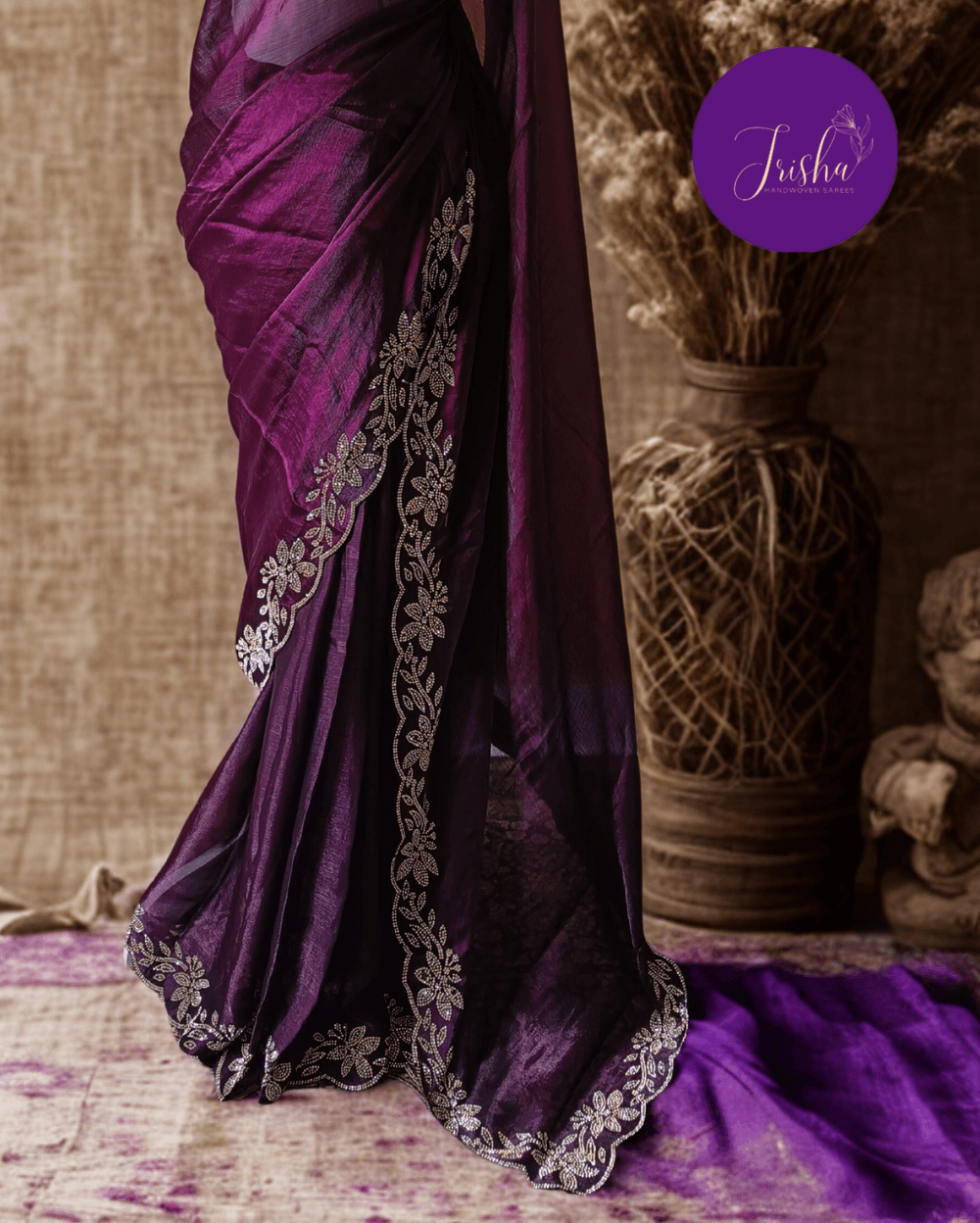 Wine Purple fendy silk saree with Jharkhan Diamond Stone crystal work in Border throughout the saree and Pallu .The Pallu is beautifully done in a C shape work pattern. The shade has a light dual tone effect. Blouse has back design in Swarovski crystal work and sleeves potion has diamond stone work done.