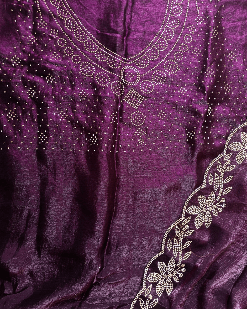 Wine Purple fendy silk saree with Jharkhan Diamond Stone crystal work in Border throughout the saree and Pallu .The Pallu is beautifully done in a C shape work pattern. The shade has a light dual tone effect. Blouse has back design in Swarovski crystal work and sleeves potion has diamond stone work done.