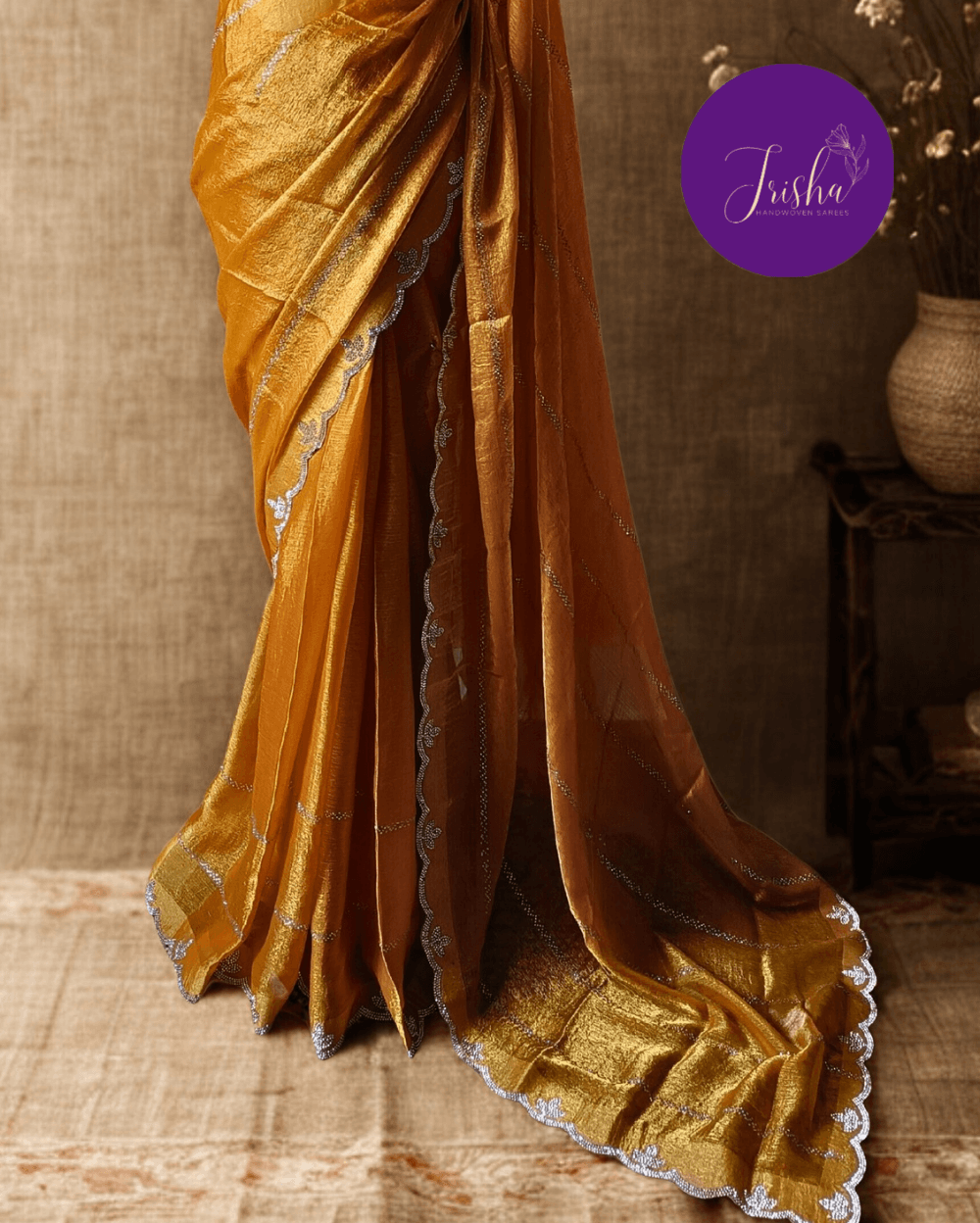 Golden Yellow fendy silk saree with Swarovski crystal work all over the shoulder and pallu portion in stripes pattern. Border throughout the saree and Pallu has diamond stone work .The saree in the skirt portion has 2 lines of striped Swarovski crystal work. The Pallu is beautifully done in a C shape work pattern. The shade has a light dual tone effect. Blouse piece has back design in Swarovski crystal work and sleeves potion has diamond stone work done.