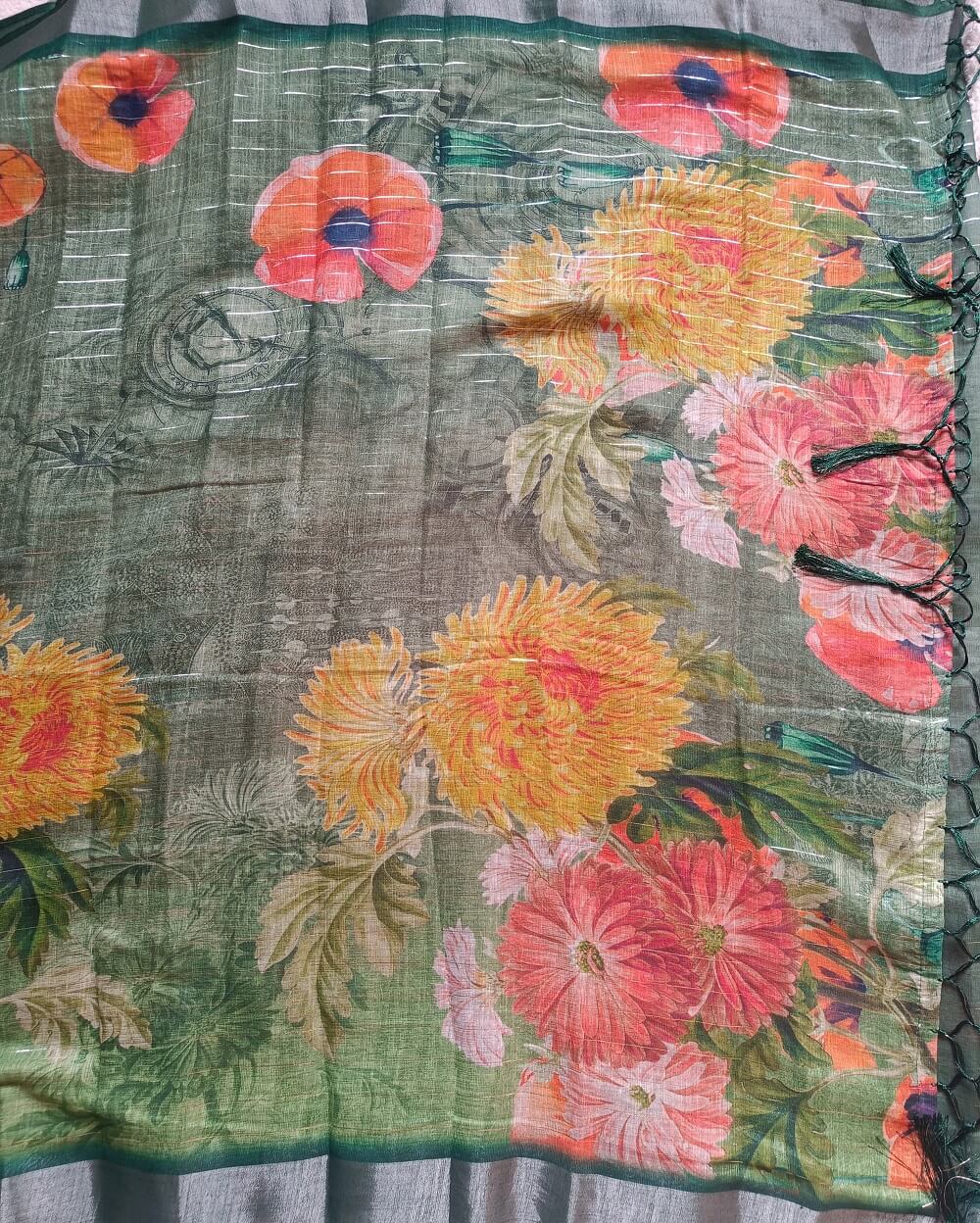 Dark Green shade Semi Linen saree with silver tissue zari border, this saree comes with digital prints all over with a subtle silver tissue zari border. The pallu is simple with prints.