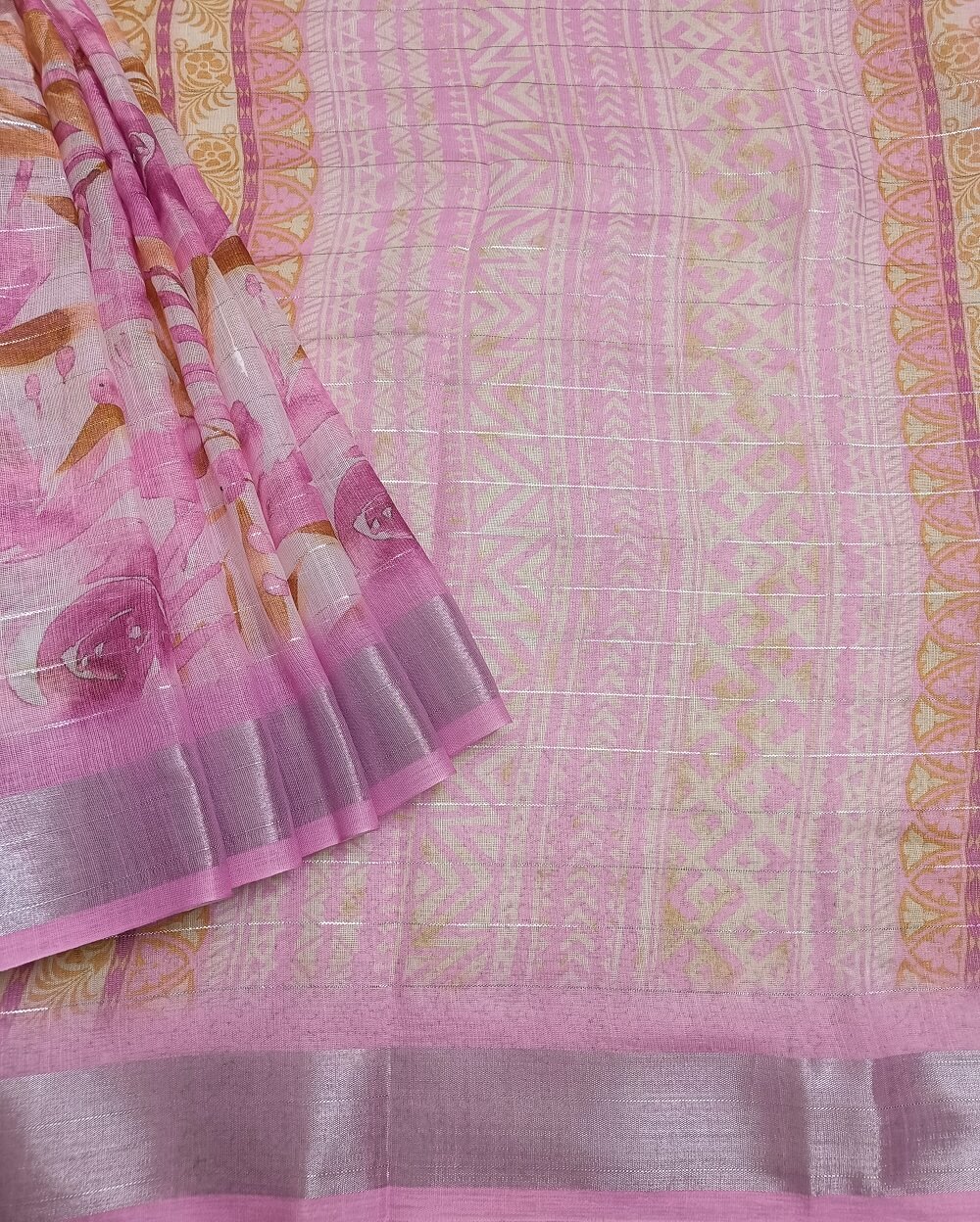 Light Pink shade Semi Linen saree with silver tissue zari border, this saree comes with digital prints all over with a subtle silver tissue zari border. The pallu is simple with prints.