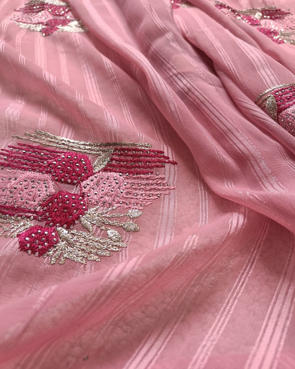 Light weight fancy Georgette Saree in Light Pink shade with Swarovski crystal work all over the shoulder and pallu portion along with embroidery floral work pattern. Border throughout the saree and Pallu has Swarovski work .The saree in the skirt portion has embroidery patterns with Swarovski crystal work. The Pallu is beautifully done in a C shape work pattern.