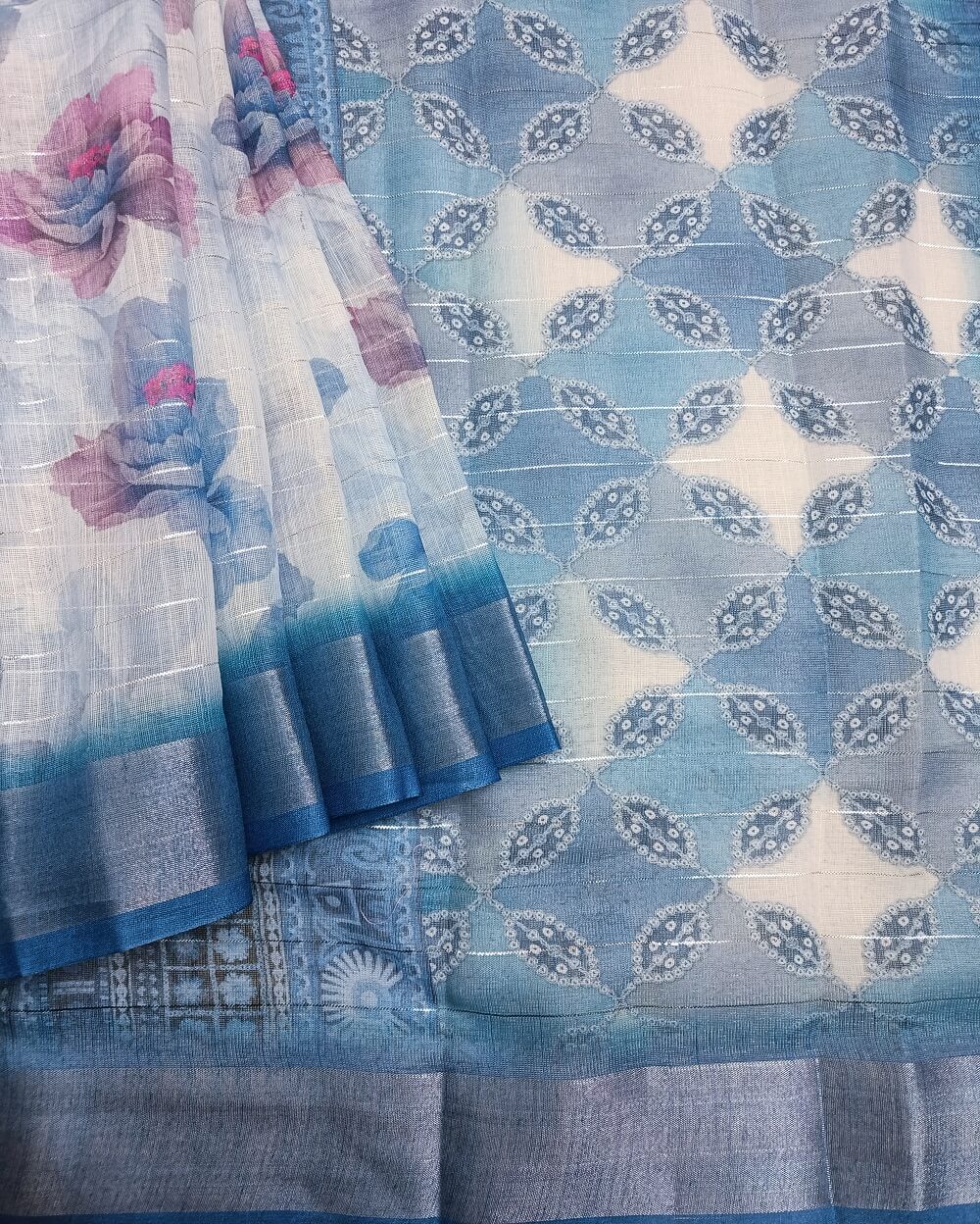 Sky Blue shade Semi Linen saree with silver tissue zari border, this saree comes with digital prints all over with a subtle silver tissue zari border. The pallu is simple with prints.