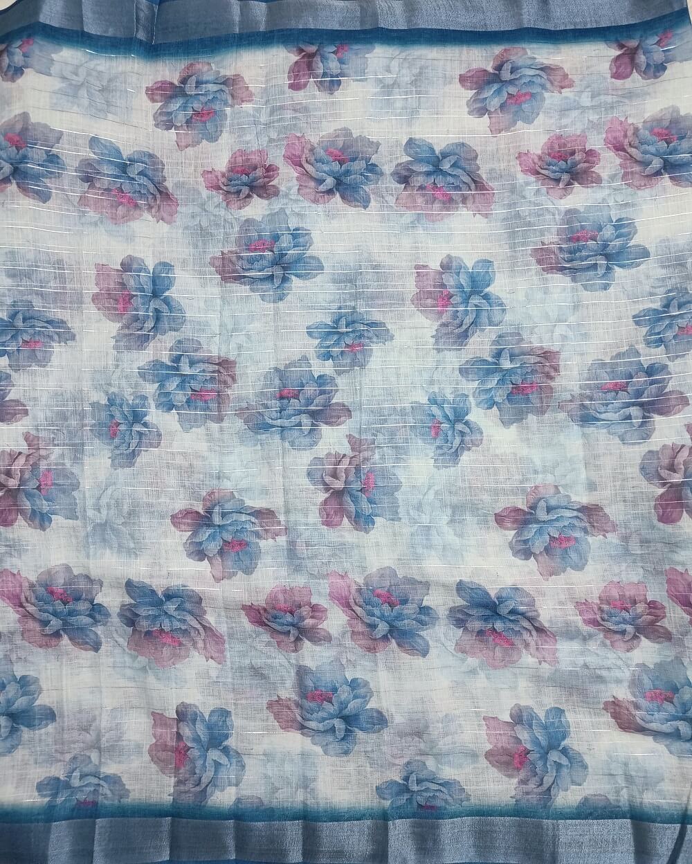 Sky Blue shade Semi Linen saree with silver tissue zari border, this saree comes with digital prints all over with a subtle silver tissue zari border. The pallu is simple with prints.