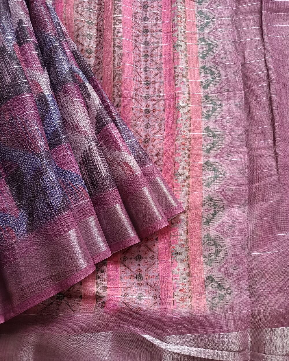 Wine shade Semi Linen saree with silver tissue zari border, this saree comes with digital prints all over with a subtle silver tissue zari border. The pallu is simple with prints.
