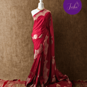 Banarasi Satin Crepe Silk in Deep Red shade with bird motifs weaves all over the body. Very unique motifs with scallop Design woven in border.It includes plain blouse piece with border in bold and contrast Dark Green shade that pairs beautifully the saree and lifts the overall look.